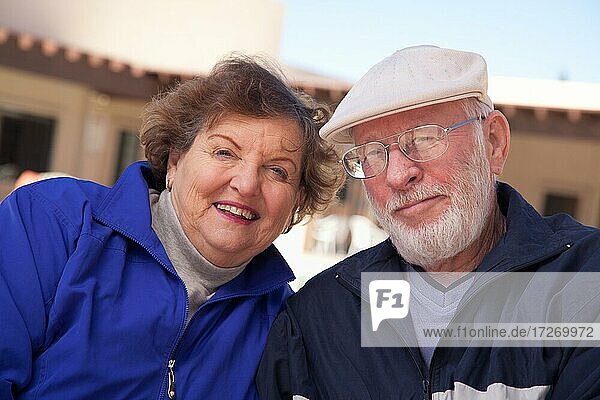 Happy senior adult couple portrait bundled up outdoors