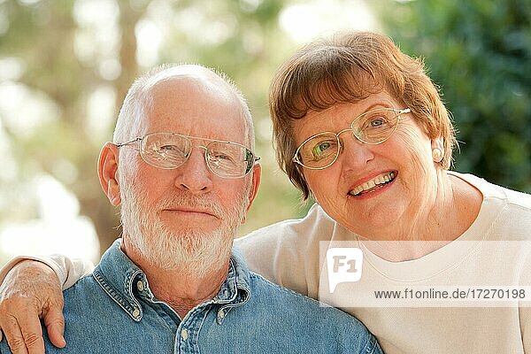 Happy affectionate smiling senior couple outdoor portrait