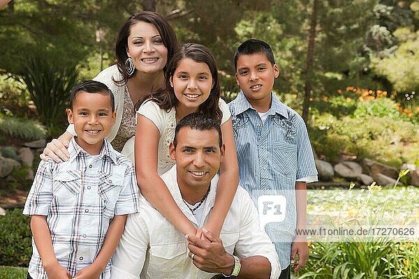 Happy hispanic family portrait in the park