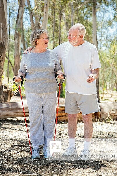 Happy healthy senior couple exercising outside together