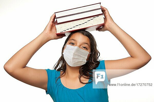 Hispanic student girl wearing face mask with books isolated on white