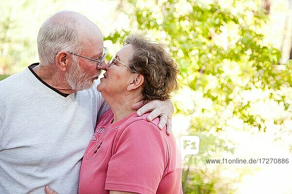 Loving senior couple kissing and enjoying the outdoors together