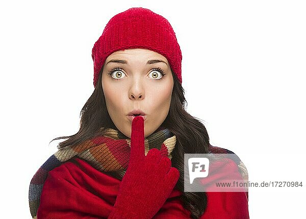 Funny faced wide eyed mixed-race woman wearing winter hat and gloves isolated on white background