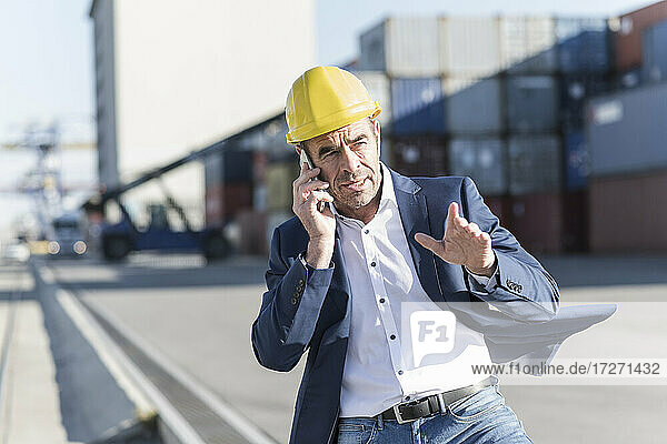 Portrait of businessman on the phone at industrial site