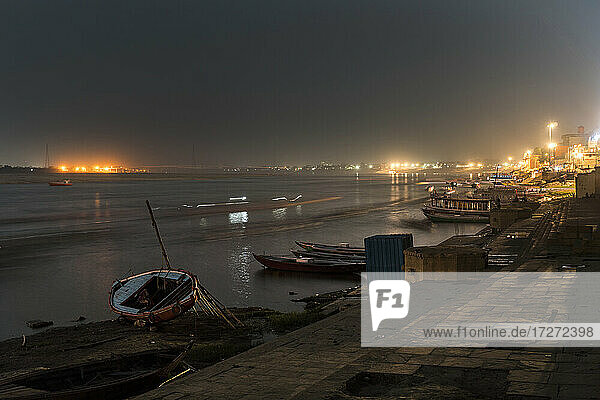 India  Uttar Pradesh  Varanasi  Boats moored along river Ganges at night