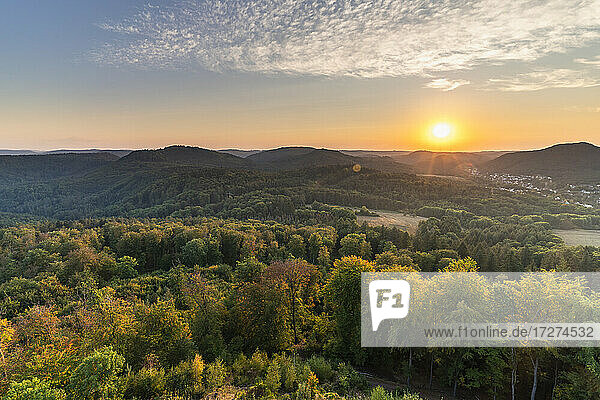 Sun setting over forested landscape of Palatinate Forest range