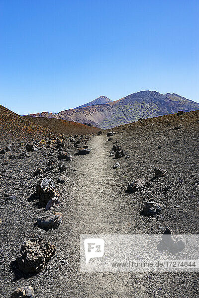 Empty trail stretching across volcanic landscape of Tenerife