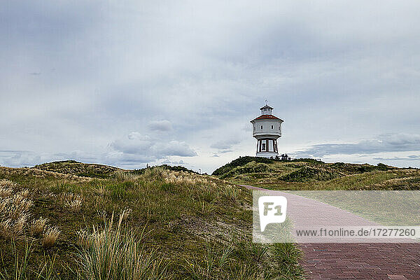 Footpath stretching in front of lighthouse on Langeoog island