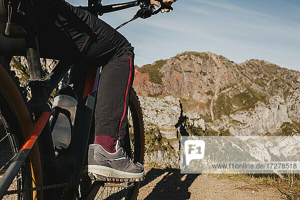 Frau auf Mountainbike im Naturpark Somiedo  Spanien  vor einem Berg stehend