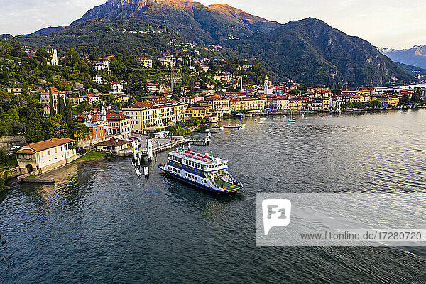 Italy  Province of Como  Menaggio  Helicopter view of ferry arriving at lakeshore town