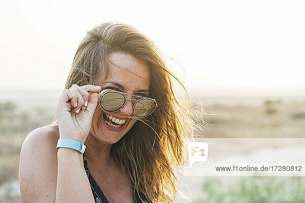 Fröhliche schöne Frau mit Sonnenbrille im Urlaub