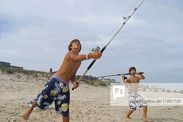 Two  brothers  fishing  at Long Beach Island  in New Jersey  USA  North America