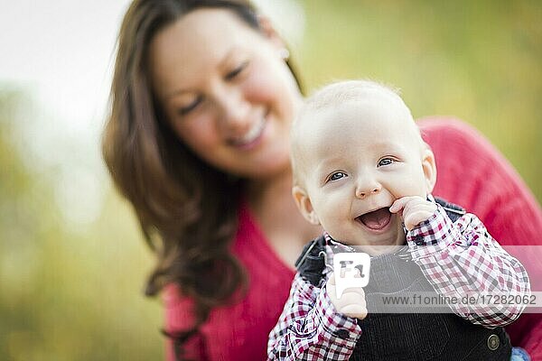 Cute little baby boy having fun with mommy outdoors