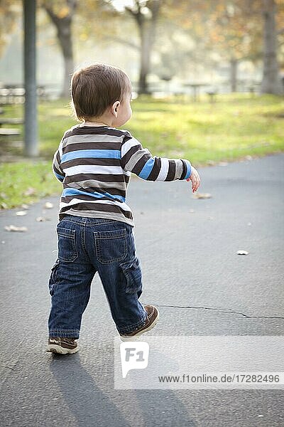 Glückliche junge Baby Junge zu Fuß in den Park
