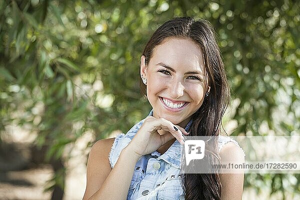 Attractive smiling mixed-race girl portrait outdoors