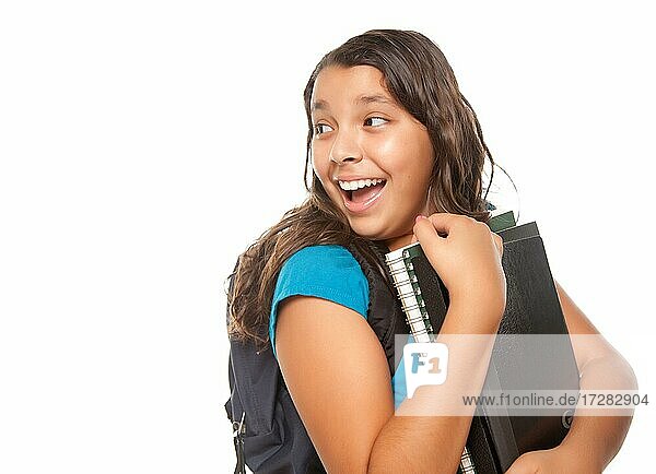 Pretty hispanic girl looking back with books and backpack ready for school isolated on a white background