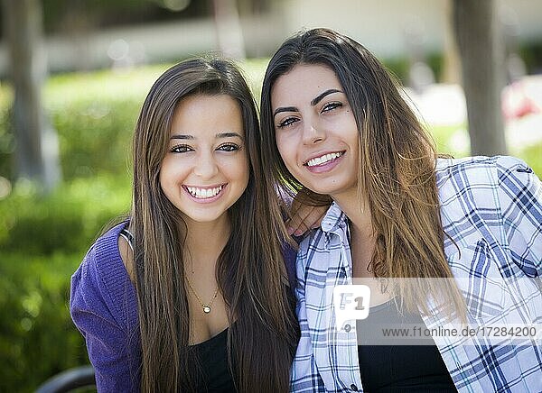 Portrait of two attractive mixed-race female friends outdoors