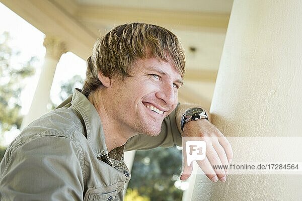 Handsome smiling young adult man portrait outside