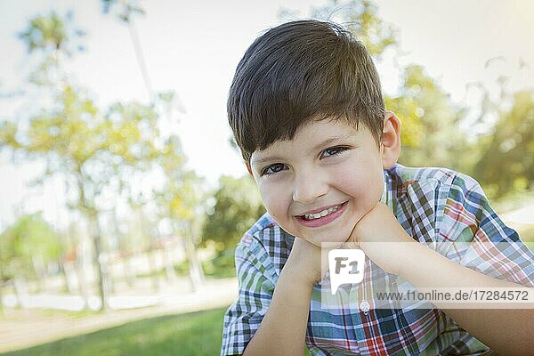 Cute young boy outdoors portrait in the park