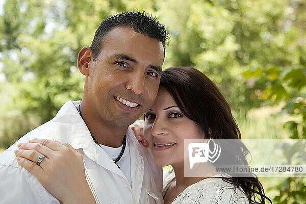 Attractive hispanic couple portrait in the park