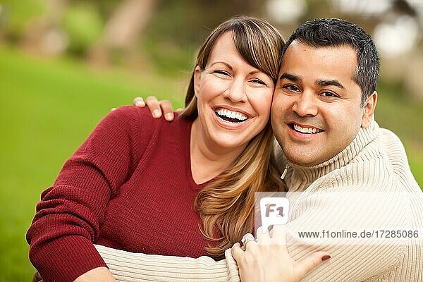 Attractive mixed-race couple portrait in the park