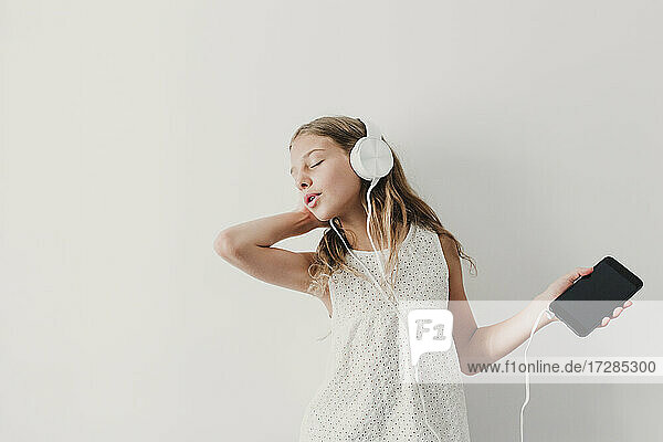 Girl with eyes closed swaying on music
