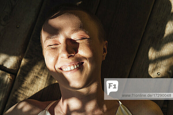 Sunlight on face of happy young woman