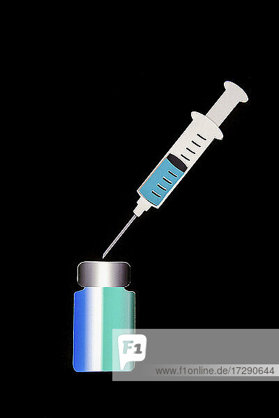 2D paper cutouts of filled syringe and bottle of vaccine