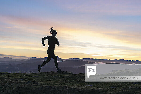 Woman running on hill