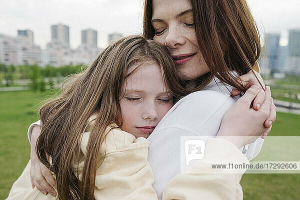 Tochter umarmt Mutter im Park