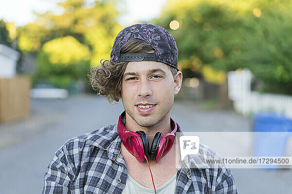 Young man with headphones at street