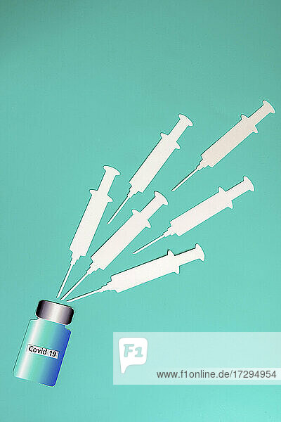 2D paper cutouts of blank syringes and bottle of vaccine