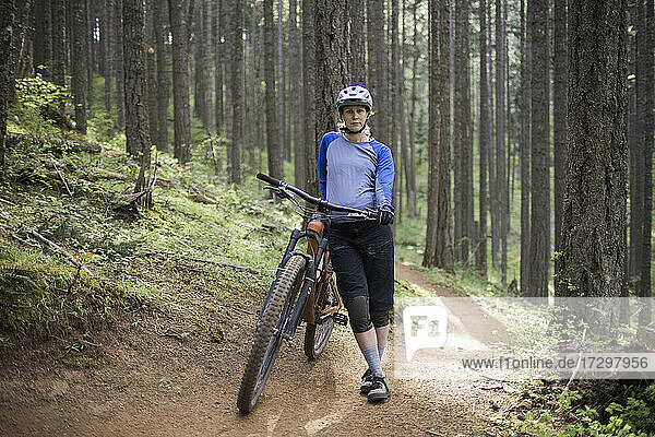 A pregnant young woman enjoys mountain biking in the Columbia River Gorge of Oregon.