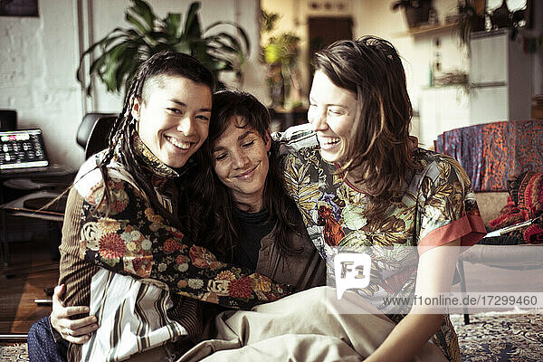 Young alternative female women friends laugh  smile and hug at home