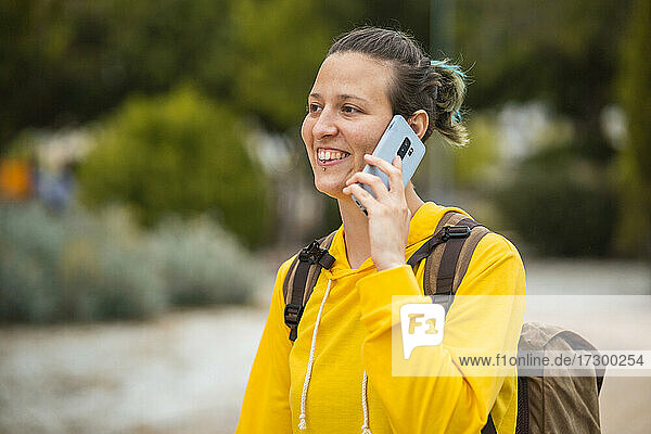 Spanish student talking on the phone while walking through university