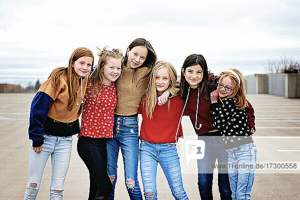 Group of 6 cute Tween girls hanging out having fun in the city.