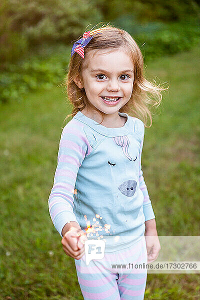 Girl Holding Sparkler on July 4th