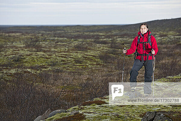 female hiker trekking through barren landscape in Skaftafell / Iceland