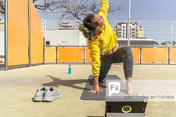 Aktive Frau während einer Yoga-Sitzung mit Tablet im Sportbereich