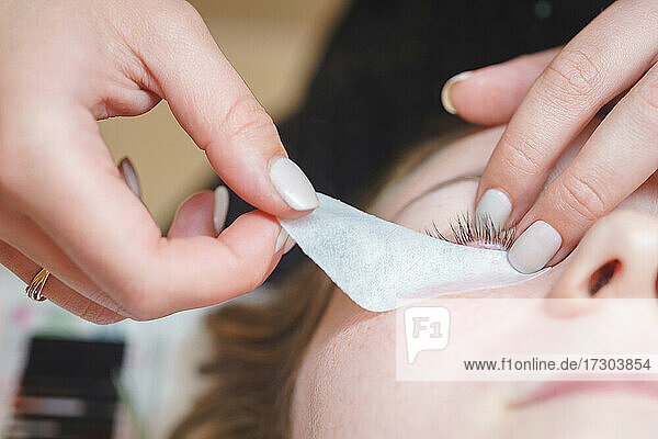 Aesthetic medicine: eyelash extension procedure for young woman