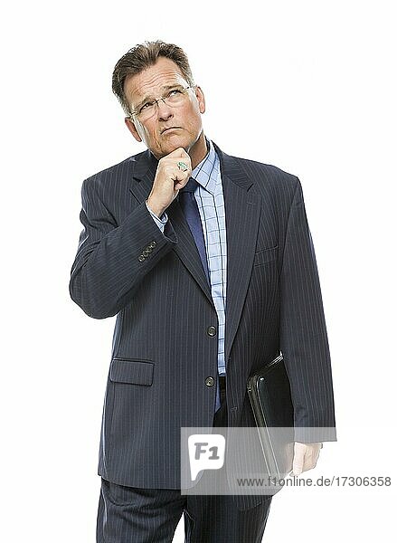 Handsome businessman with hand on chin and looking up and over isolated on a white background