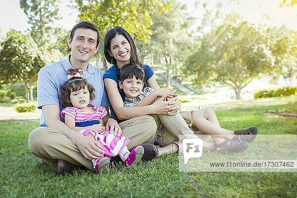 Attractive young mixed-race family portrait in the park