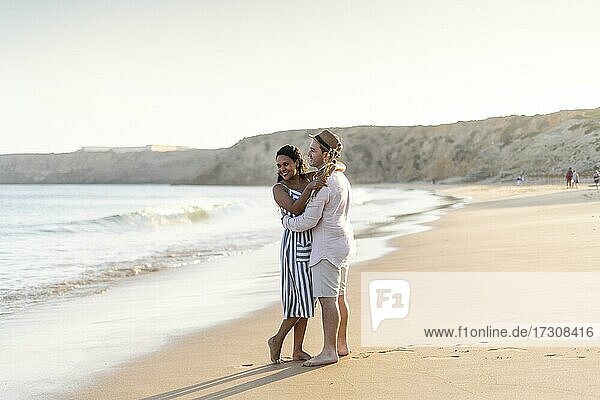 Young couple enjoying time together on the beach in Algarve  Portugal  Europe