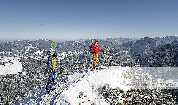 Young woman and man on ski tour  ski tourers on tour to Teufelstättkopf  Ammergau Alps  Unterammergau  Bavaria  Germany  Europe