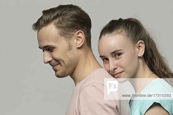 Studio portrait confident young couple