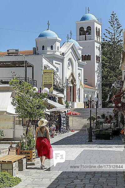 Junge Frau mit Kleid spaziert durch Fußgängerzone  Kirche Agia Paraskevi  Altstadt von Kos  Dodekanes  Griechenland  Europa