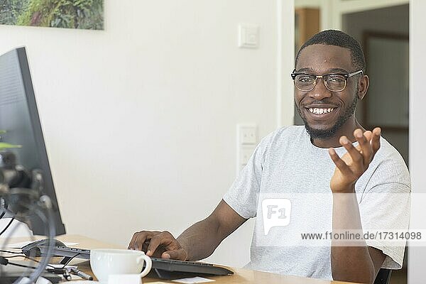 Young black man working at desk in office  Freiburg  Baden-Württemberg  Germany  Europe