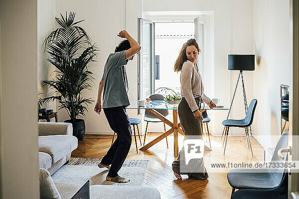 Couple having fun while dancing at home