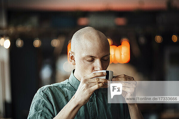 Male cafe owner drinking coffee