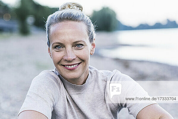 Mature woman smiling at riverbank